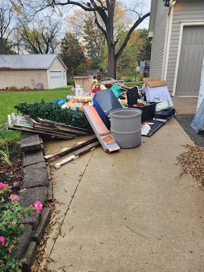 Dumpster being loaded with debris for 12 Yard Dumpster Rental in Gonzales